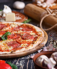 Tender pizza with sausage, tomatoes and cheese