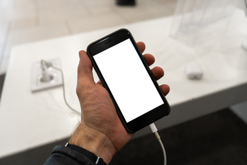 Real life use of phone in a men's hand holding with free copy space for your ad and text - Mock up billboard and empty screen