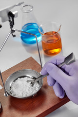 Pharmacist or scientist preparing medicine using precision weighing
