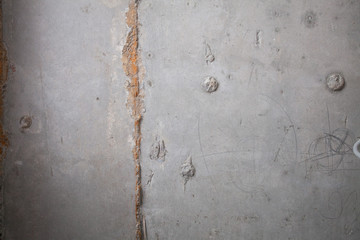 Formwork traces on concrete. Repair and construction or constructing. Concrete background. Grey color. Cement texture. Poor quality curve wall. Flaws, defects and cracks in the wall. .