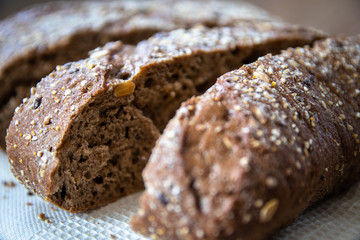 Homemade healthy freshly baked organic whole grain bread with healthy seeds on wooden table