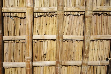 Woven bamboo wall panel with overlapping slats horizontal background