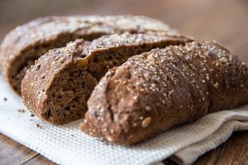 Homemade healthy freshly baked organic whole grain bread with healthy seeds on wooden table