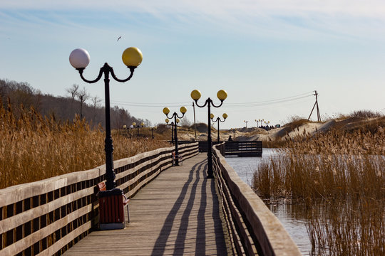 Wooden sidewalk on lake at Baltic sea beach