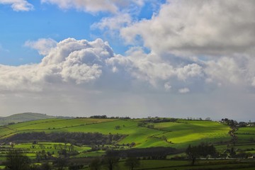 Fototapeta na wymiar Scenic view of Irish hills and white clouds 