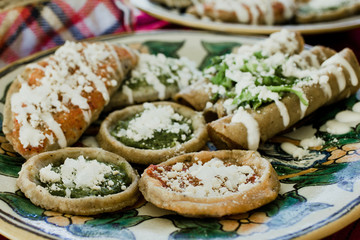 sopes, tacos dorados and flautas de pollo, Mexican food, spicy sauce in Mexico