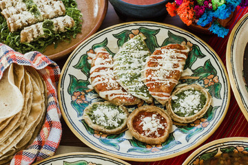 sopes, tacos dorados and flautas de pollo, Mexican food, spicy sauce in Mexico