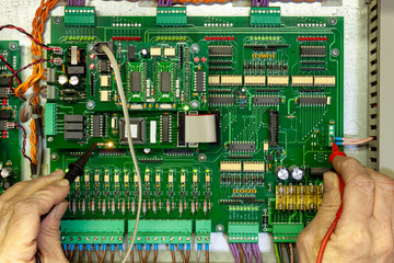 Electronics test engineer testing a digital circuit board