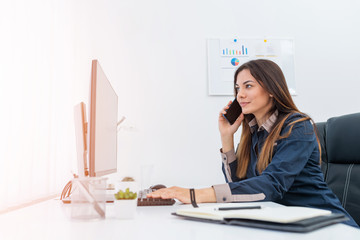 Female secretary having a conversation and taking notes