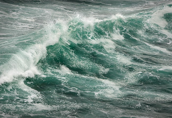 Breaking Surf. Waves break and crash on a rough sea.