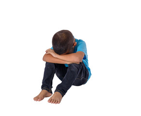 Sad little asian boy sitting on floor isolated on white background