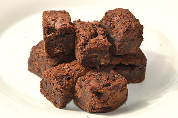 Delicious Chocolate Brownies group closeup on a white plate with blurred background.