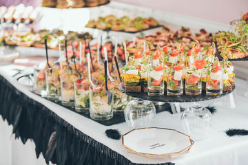 Catering service. Catering food. Table with food at event. Beautifully decorated catering banquet table with different food snacks and appetizers with sandwich.