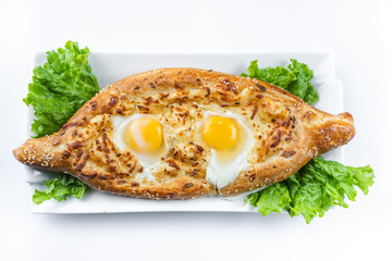 Khachapuri in Adjarian. Open pie with mozzarella and egg. Georgian cuisine.