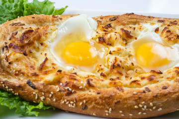 Khachapuri in Adjarian. Open pie with mozzarella and egg. Georgian cuisine.