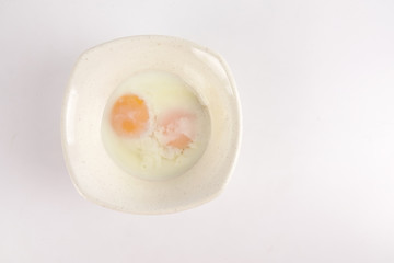 Half boiled egg isolated on white.