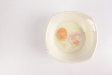Half boiled egg isolated on white.