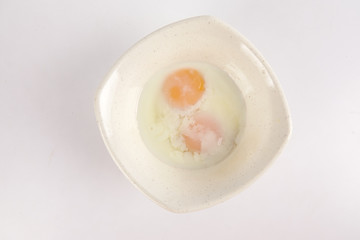Half boiled egg isolated on white.