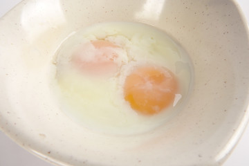 Half boiled egg isolated on white.