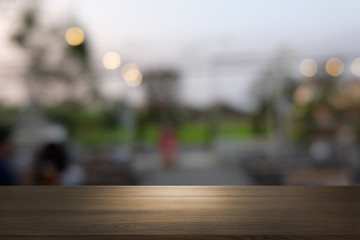 Empty dark wooden table in front of abstract blurred bokeh background of restaurant . can be used for display or montage your products.Mock up for space.