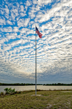 American flag wavering against morning sky in the Press Area at Kennedy Space Center