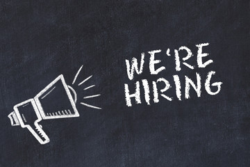 Chalk board sketch with loudspeaker and phrase were hiring