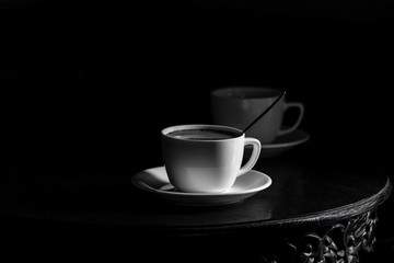 White cups of coffee on black background - coffee for two on a table