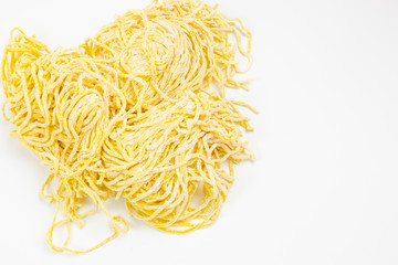 Yellow noodles are placed on a white background