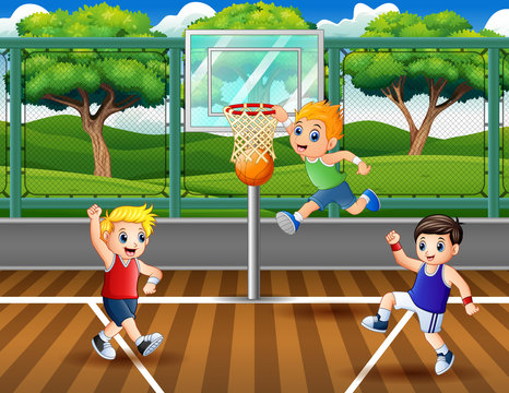 Three boys playing basketball at the court