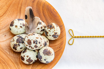 Quail eggs in a wooden bowl