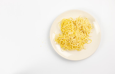 Yellow noodles are placed on a white background