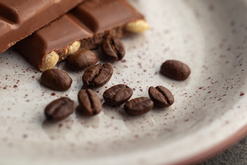Coffee beans and dark chocolate glaze on the plate