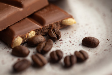 Coffee beans and dark chocolate glaze on the plate