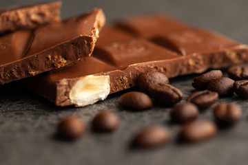 Coffee beans and dark chocolate glaze on gray background