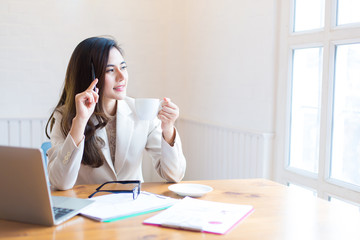 Protrait of Beautiful businesswoman sitting at desk and working with laptop computer.