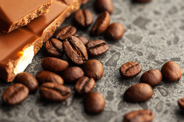 Coffee beans and dark chocolate glaze on gray background