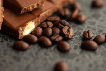 Coffee beans and dark chocolate glaze on gray background