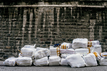 ISTANBUL, TURKEY - SEPTEMBER 2018: Large white bags on the background of the wall of wild stone dark gray