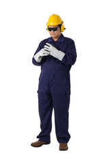 portrait of a worker in Mechanic Jumpsuit is Removing gloves isolated on white background