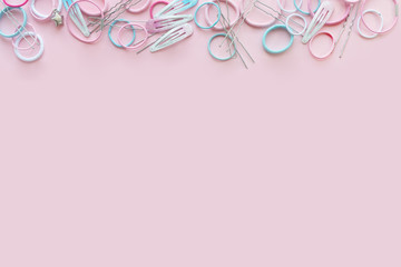 Hair scrunchies and hairpins on pink background, beauty concept, flat lay