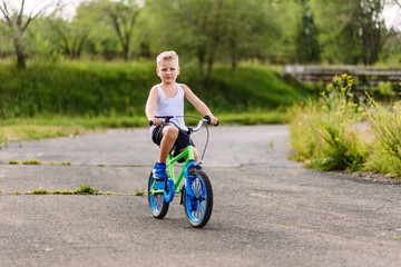 Fototapeta na wymiar a boy rides a bike