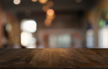 Empty dark wooden table in front of abstract blurred bokeh background of restaurant . can be used for display or montage your products.Mock up for space.