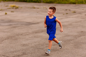 five-year-old boy running on asphalt