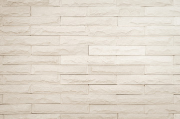 Seamless Cream pattern of decorative brick sandstone wall surface with concrete of modern style design decorative uneven have cracked realmasonry wall of multicolored stones or blocks white cement.