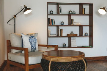 Hotel hall room with lamp, books and armchair