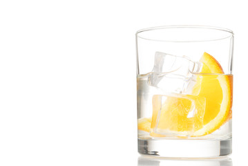 Summer cocktal with water, ice and orange slice, isolated, copy space. White background