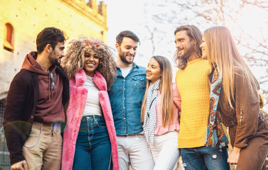 Fototapeta premium group of young people having fun together having free time in an outdoor environment. Vivid image, filtered.