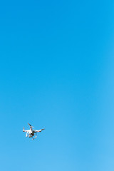 Drone flying against blue sky