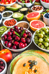 Fresh fruits and other healthy food. Organic breakfast containing superfoods, vegetarian nutrition like nourishing fruit, nuts and seeds.