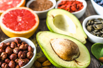 Fresh avocado and other healthy food. Organic breakfast containing super foods, nutrition like fruits, nuts and seeds.